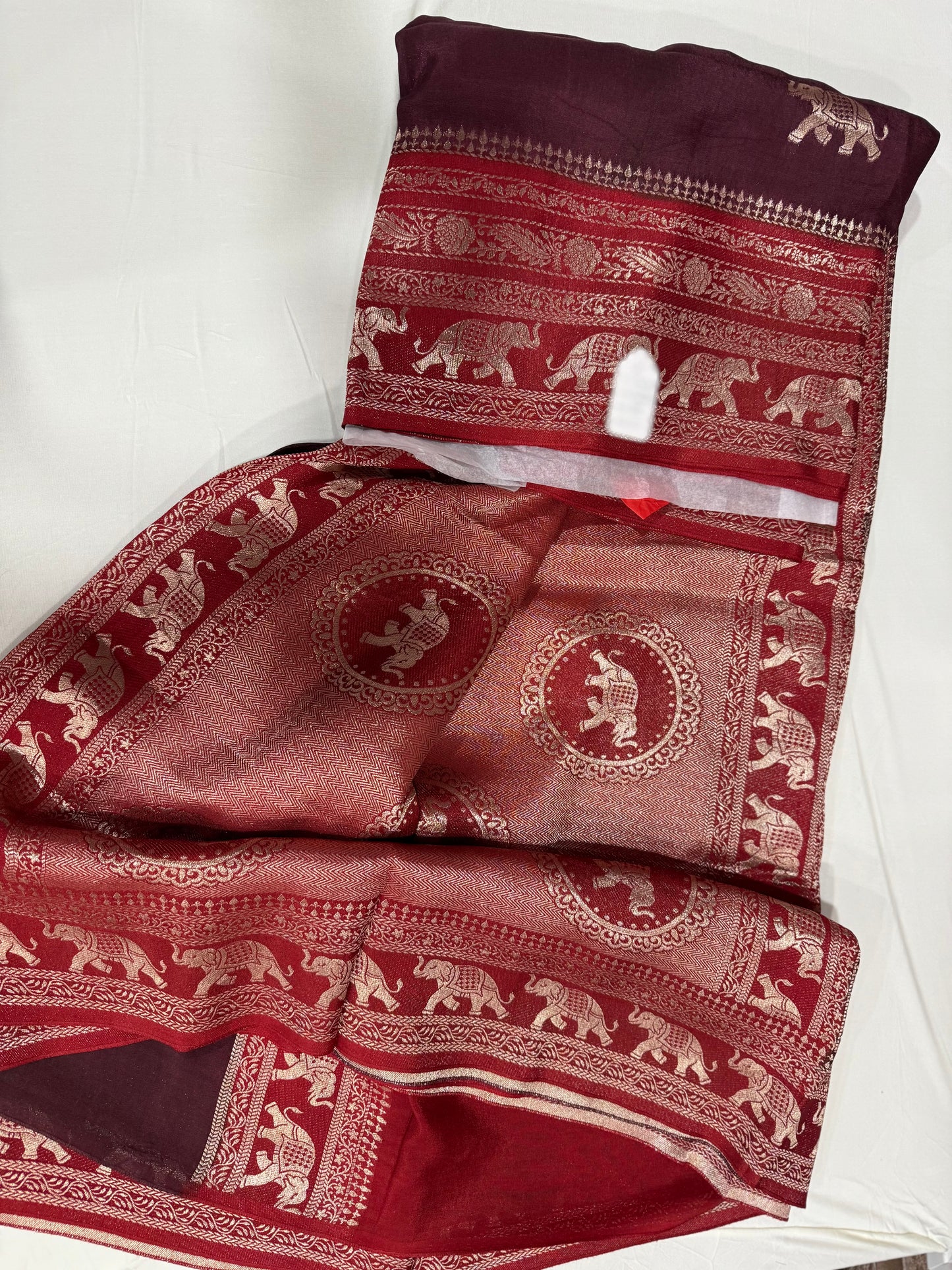 Viscose georgette silk saree in brown with maroon zari pallu