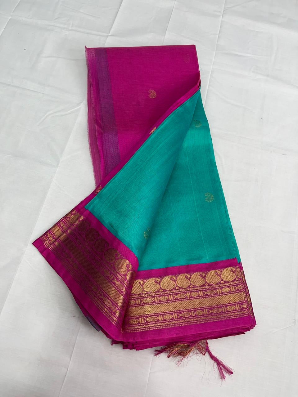 Silk cotton saree in teal with pink korvai zari border
