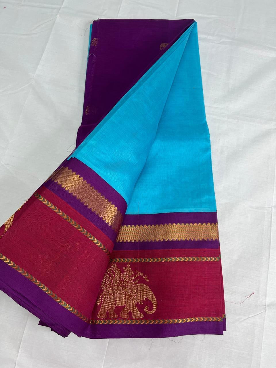 Light blue Silk cotton saree with red and purple korvai zari border